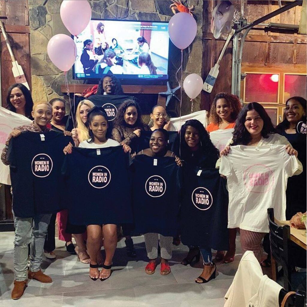 Women holding up shirts