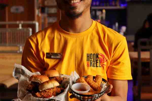 Waiter holding food baskets