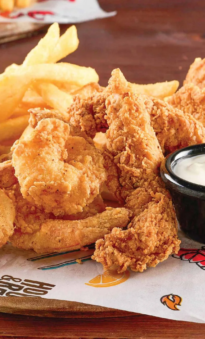 A basket of fried chicken tenders and french fries